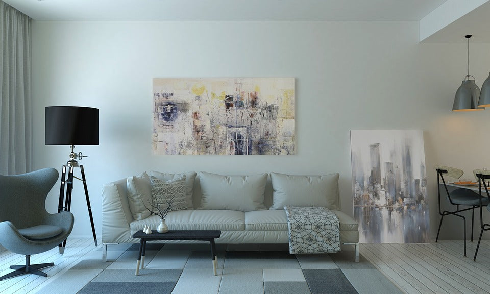 Difrent size of art in a large living room.