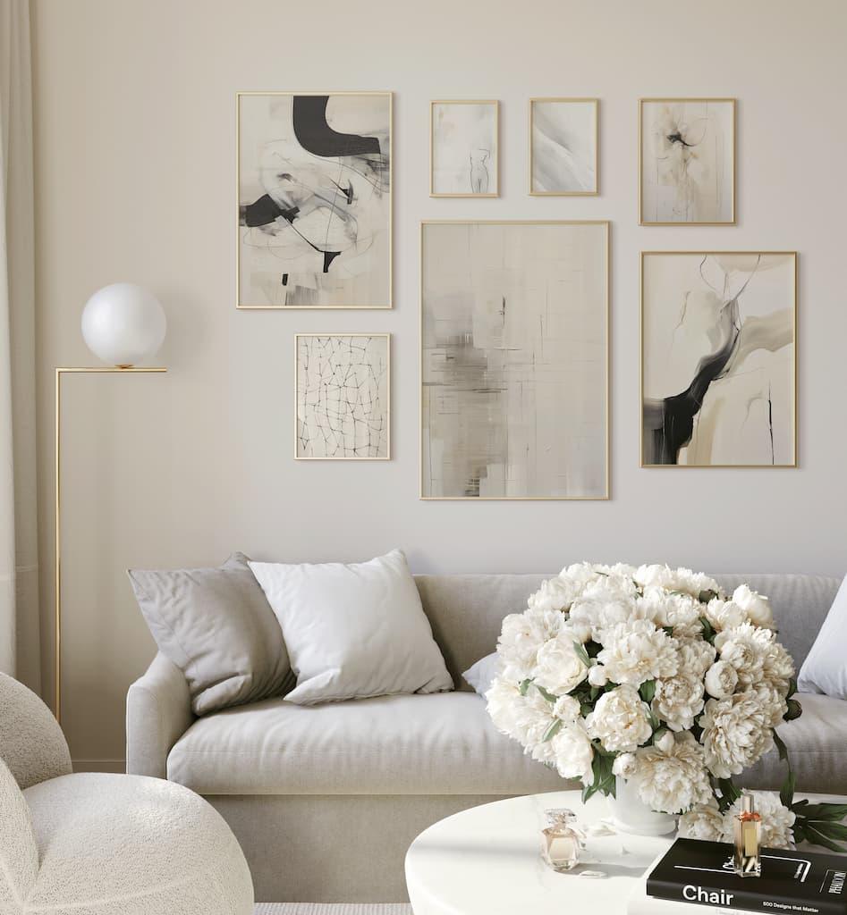 Modern living room with a gray sofa, abstract art on the wall, and a vase of white flowers.